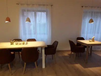 a dining room with two tables and chairs at Garni Unterspeiser in Terlano