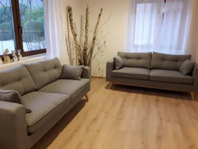 a living room with two couches and a window at Garni Unterspeiser in Terlano