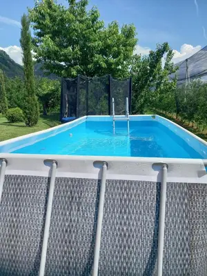 a swimming pool with a fountain on a deck at Garni Unterspeiser in Terlano