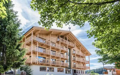 a building with balconies on the side of it at Hotel Madonna in Castelrotto