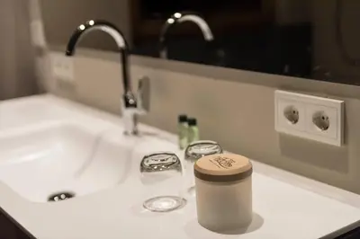 a coffee cup sitting on a bathroom sink at Hotel Madonna in Castelrotto
