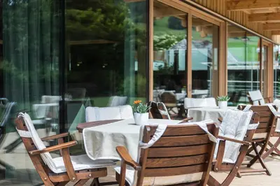 a group of tables and chairs on a patio at Hotel Madonna in Castelrotto