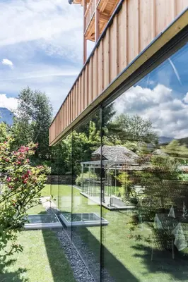 a glass house with a view of a garden at Hotel Madonna in Castelrotto