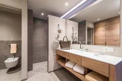 a bathroom with a sink and a mirror at Hotel Madonna in Castelrotto
