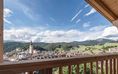 a view of a town from the balcony of a house at Hotel Madonna in Castelrotto
