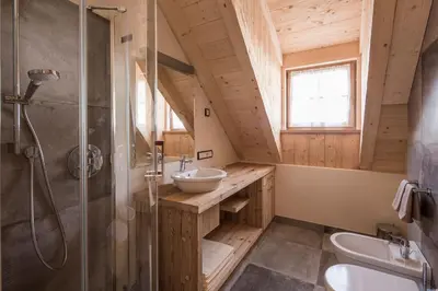 a bathroom with a sink and a shower at Osti Nicl in San Martino in Badia