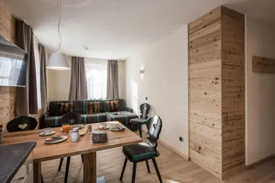a living room with a table and a couch at Osti Nicl in San Martino in Badia