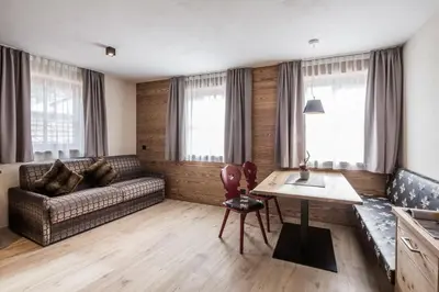 a living room with a couch and a table at Osti Nicl in San Martino in Badia