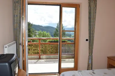a room with a door open to a balcony at Gasthaus zum Weissen Kreuz in Lazfons