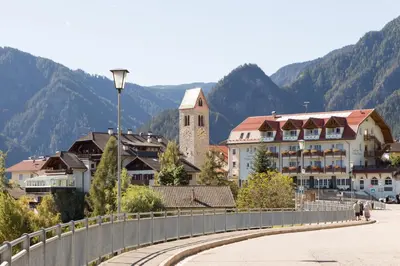 a town with a bridge and mountains in the background at Gasthaus zum Weissen Kreuz in Lazfons