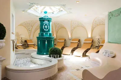 a room with a fountain in the middle of a room at Hotel MAYR in Castelrotto