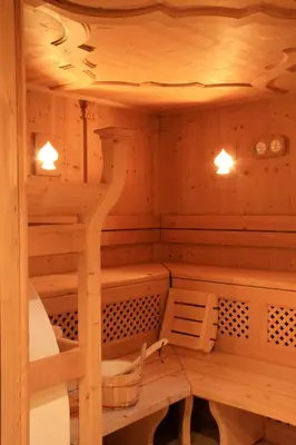 a sauna with wooden walls and shelves and lights at Hotel MAYR in Castelrotto