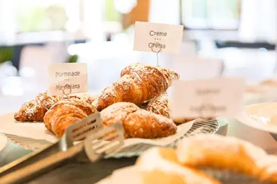 a display of croissants and other pastries on a table at Hotel MAYR in Castelrotto