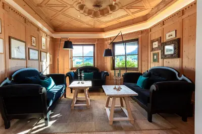 a living room with couches and a table at Hotel MAYR in Castelrotto