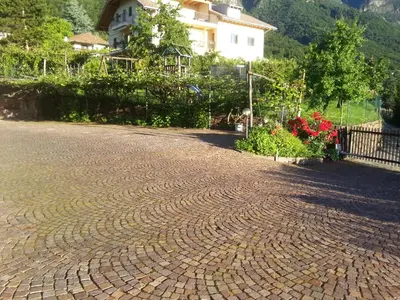 a brick road in front of a house at Gästehaus Thaler in Caldaro