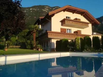 a house with a swimming pool in front of it at Gästehaus Thaler in Caldaro