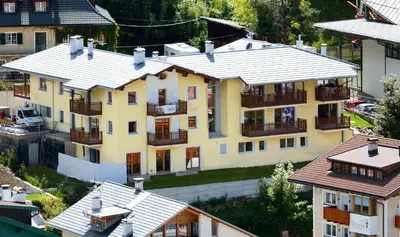 an overhead view of a large yellow house with balconies at Cesa Setil in Ortisei