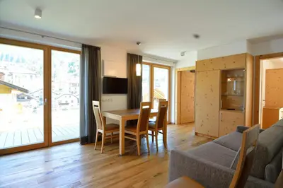 a living room with a table and a couch at Cesa Setil in Ortisei