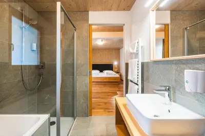 a bathroom with a sink and a shower at Hotel Tirolerhof in Terento
