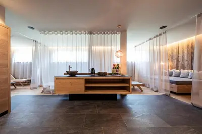 a living room with a sink and a couch at B&B Boutiquehotel Clara in Brunico