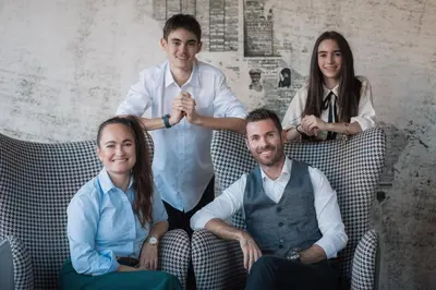 a group of three people sitting in chairs at B&B Boutiquehotel Clara in Brunico