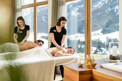 a group of women getting a massage in a spa room at Bella Vista Hotel Emma in San Vigilio Di Marebbe