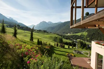 a view of the mountains from a house at Bella Vista Hotel Emma in San Vigilio Di Marebbe