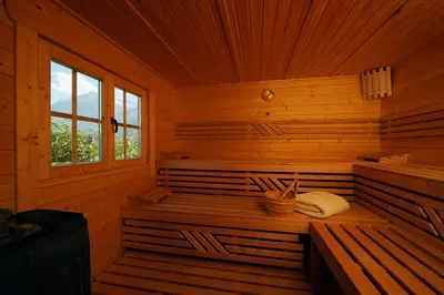 a wooden cabin with a sauna with a window at Hotel Garni Partaneshof in Merano