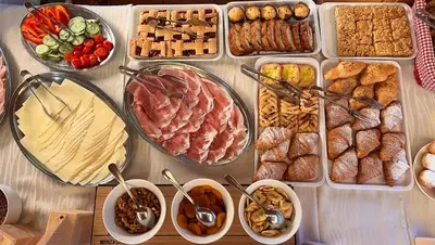 a table with many different types of food on it at Hotel Aurora in Canazei