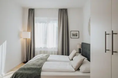 a room with a table and chairs in a building at Feichter Hotel & Living in Bolzano