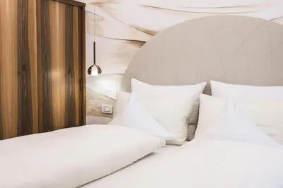 a bedroom with two beds with white pillows at Apartments Villa Venezia Luxury in Ortisei