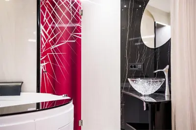 a bathroom with a sink and a red wall at Apartments Villa Venezia Luxury in Ortisei