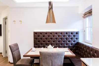 a dining room with a table and chairs at Apartments Villa Venezia Luxury in Ortisei