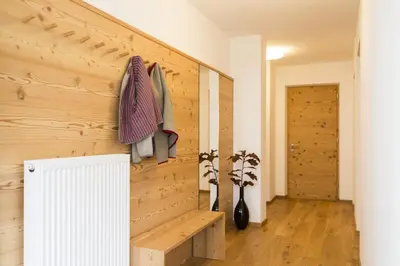 a room with a wooden wall and a bench at Residence Luzerna *** in Selva di Val Gardena