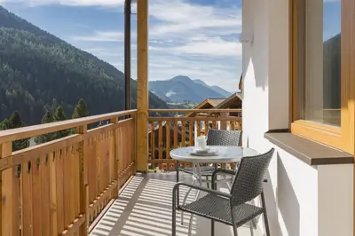 a dining room with a wooden table and chairs at Residence Luzerna *** in Selva di Val Gardena