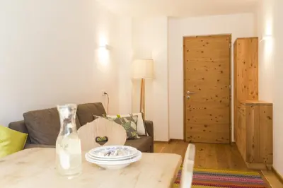 a dining room with a wooden table and chairs at Residence Luzerna *** in Selva di Val Gardena