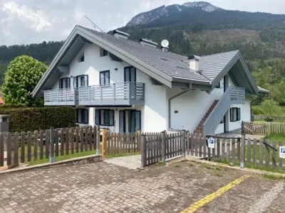 a white house with a fence in front of it at Casa Fam.Barbolini in Tesero