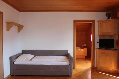 a bedroom with two beds and a window at Ciasa Nea in Longega