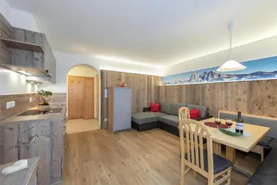 a kitchen and living room with a table and a couch at Bergdiamant in Maranza