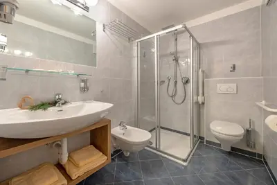 a bathroom with a sink and a shower and a toilet at Bergdiamant in Maranza