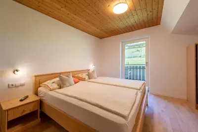 a bedroom with a bed and a window at Haus Stolz in Appiano sulla Strada del Vino