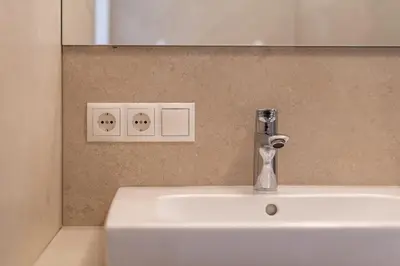 a bathroom sink with a faucet and a mirror at Haus Stolz in Appiano sulla Strada del Vino