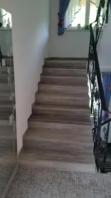 a staircase in a house with a stair case at Pension Weinberg in Rifiano