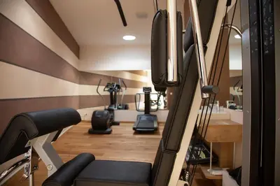 a gym with two treadmills and a treadmill at Romantik Chalet im Weingut Eichenstein in Merano
