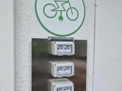 a sign on a wall with a bike on it at Hofer Hof in Andrian