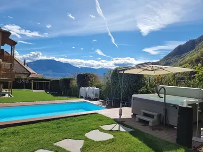 a backyard with a swimming pool and an umbrella at Hofer Hof in Andrian