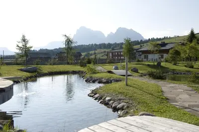 a river with rocks around it in a village at Seiser Alm Urthaler in Alpe di Siusi
