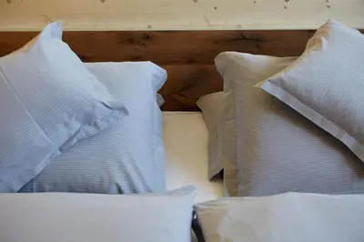 a group of white pillows on a bed at Seiser Alm Urthaler in Alpe di Siusi