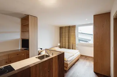 a small kitchen with a sink and a television at Seiser Alm Plaza in Alpe di Siusi