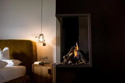 a hotel room with a fire in a fireplace at Romantik Hotel Turm in Fiè